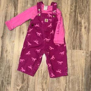 Light worn baby girls Carhartt long sleeve bodysuit and overalls set.